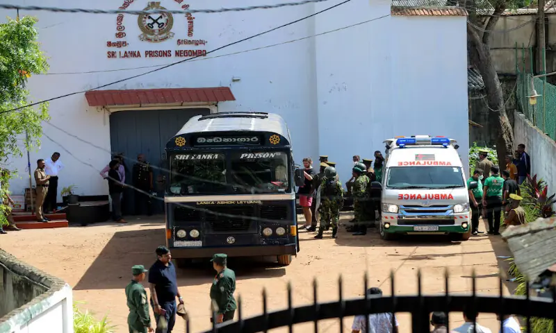 Prisoners board a bus to be transferred to another prison following clashes between two groups of inmates at Negombo Prison, in the coastal town of Negombo, Sri Lanka, on Monday. -- Reuters