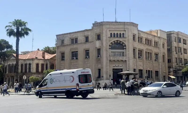 An ambulance drives past the site where explosive devices blew up near a hotel where French President Emmanuel Macron was meant to be staying, in Damascus, Syria, on Tuesday. -- Reuters