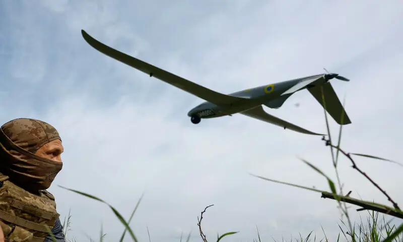 A service member of the Ukrainian Armed Forces looks at a Shark reconnaissance drone at an undisclosed location in southern Ukraine. -- Reuters