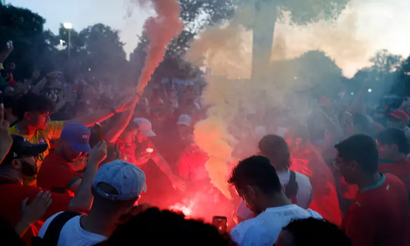 Morocco fans light flares as they gather on Boston Common ahead of their game against France. -- Reuters Morocco fans light flares as they gather on Boston Common ahead of their game against France. -- Reuters