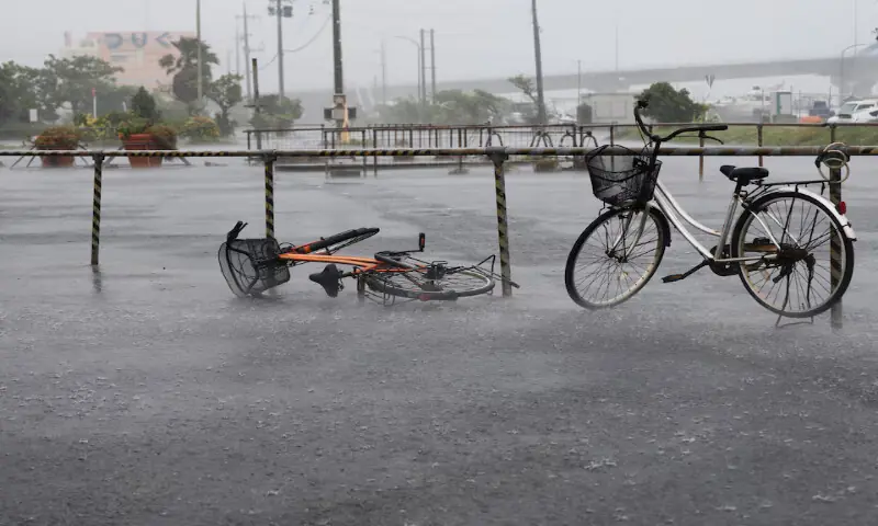 A bicycle falls on the ground in the heavy rain as Typhoon Bavi approaches Ishigaki, Japan. -- Reuters