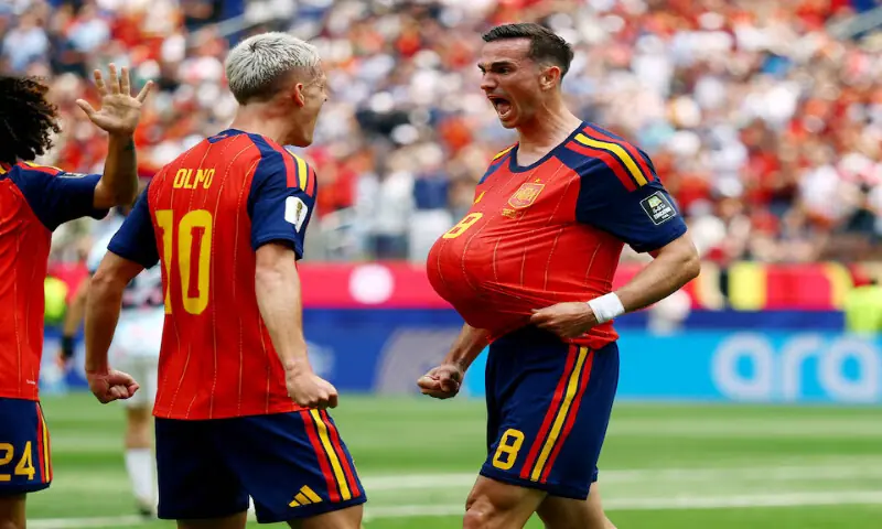 Spain's Fabian Ruiz celebrates scoring their first goal with Dani Olmo. -- Reuters