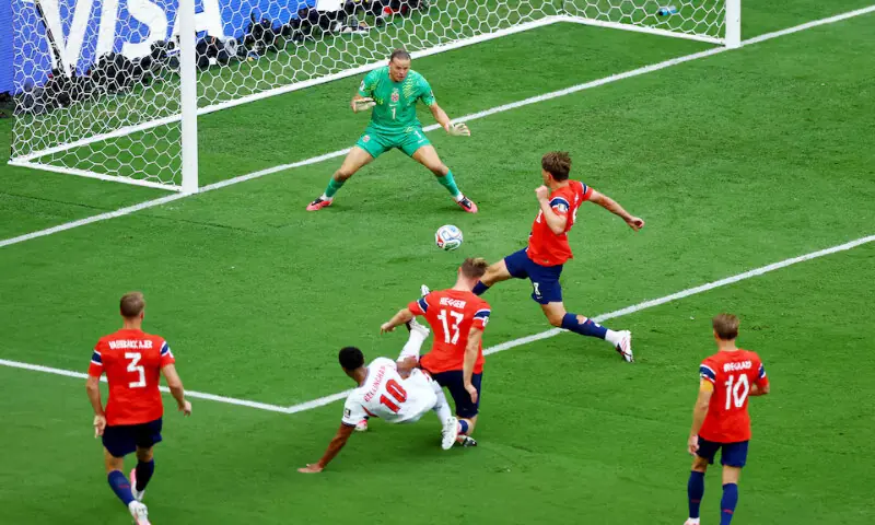 England's Jude Bellingham scores their first goal past Norway's Orjan Nyland. -- Reuters England's Jude Bellingham scores their first goal past Norway's Orjan Nyland. -- Reuters