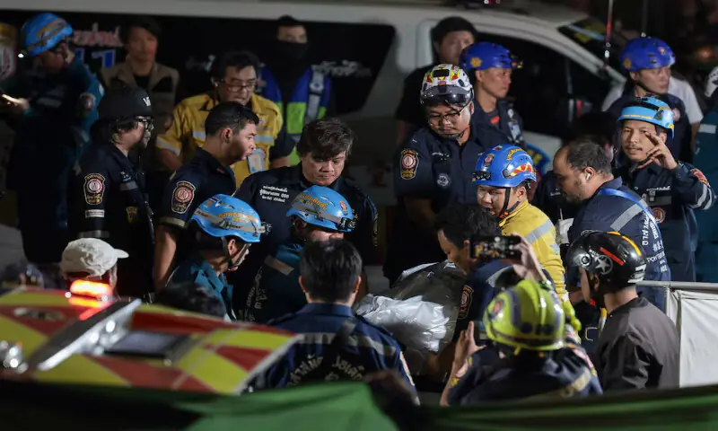 Members of emergency personnel transfer the body of a deceased person at the site of a deadly fire at a pub in Bangkok, Thailand, on Monday. -- Reuters