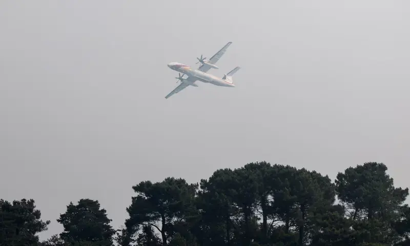 Aerial firefighting plane, De Havilland Canada Dash 8-402 MR, flies as French firefighters battle a wildfire in the Fontainebleau forest in Noisy-sur-Ecole near Paris on Monday. -- Reuters