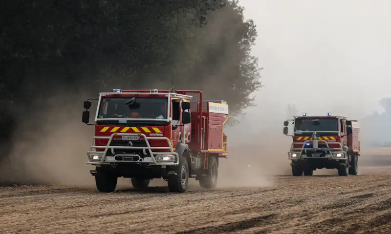Fire trucks drive as French firefighters battle a wildfire in the Fontainebleau forest in Noisy-sur-Ecole near Paris on Monday. -- Reuters