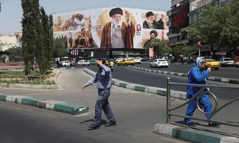 People walk past a billboard featuring images of Iran's late Supreme Leader Ayatollah Ali Khamenei in Tehran, Iran. -- Reuters People walk past a billboard featuring images of Iran's late Supreme Leader Ayatollah Ali Khamenei in Tehran, Iran. -- Reuters