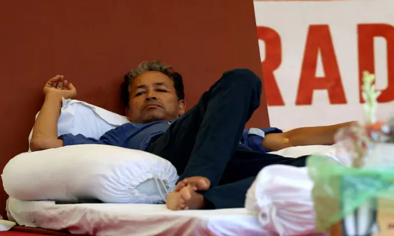 Sonam Wangchuk, who has been on hunger strike, rests on stage during a sit-in protest demanding the resignation of Indian Education Minister Dharmendra Pradhan, at Jantar Mantar in New Delhi, India, on Tuesday. -- Reuters Sonam Wangchuk, who has been on hunger strike, rests on stage during a sit-in protest demanding the resignation of Indian Education Minister Dharmendra Pradhan, at Jantar Mantar in New Delhi, India, on Tuesday. -- Reuters