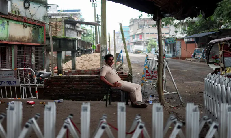 A police officer sits as he guards a street following the rape and murder of an 11-year-old girl in a town near Kolkata, West Bengal, India. -- Reuters A police officer sits as he guards a street following the rape and murder of an 11-year-old girl in a town near Kolkata, West Bengal, India. -- Reuters