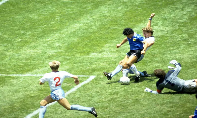 [2/3] Football - 1986 FIFA World Cup - Quarter Final - England v Argentina - Azteca Stadium, Mexico City - 22/6/86 Diego Maradona scores for Argentina in the 1986 FIFA World Cup match against England at Azteca Stadium, Mexico City. -- Reuters