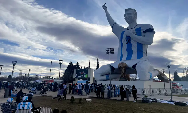 People gather by a statue of Argentina's revered Lionel Messi while watching the World Cup semi-finals between Argentina and England, in Cutral Co, in the Patagonian province of Neuquen, Argentina. -- Reuters
