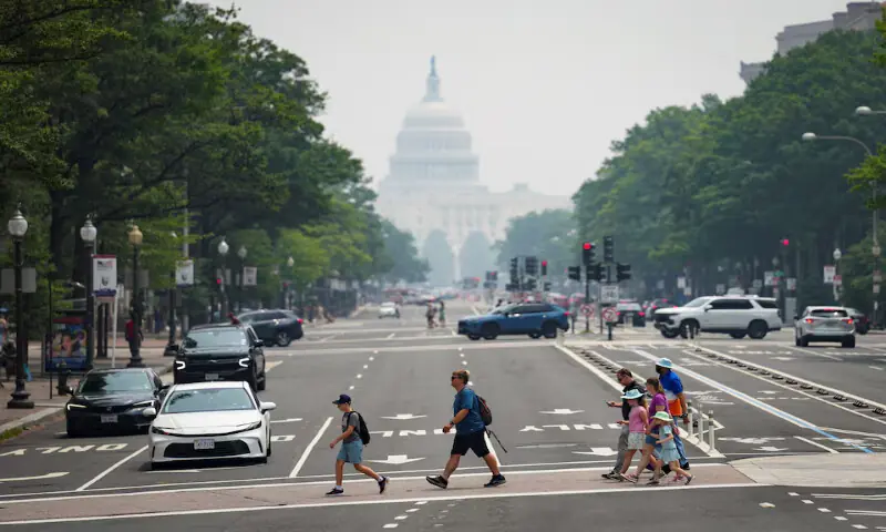 Pedestrians cross Pennsylvania Avenue near the US Capitol in smoky conditions due to the Canadian wildfires, in Washington, DC. -- Reuters