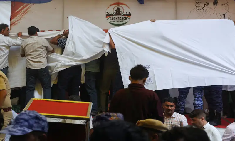 Authorities cover the stage with plain cloths as they prepare to take Sonam Wangchuk to the hospital in New Delhi, India, on Saturday. -- Reuters