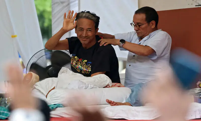 Sonam Wangchuk gestures as he recieves a back massage during a sit-in protest at Jantar Mantar in New Delhi, India. -- Reuters