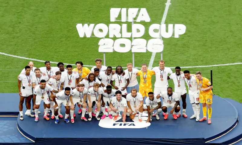England manager Thomas Tuchel and England players wear their bronze medals as they pose for a picture on the podium after the match. -- Reuters England manager Thomas Tuchel and England players wear their bronze medals as they pose for a picture on the podium after the match. -- Reuters