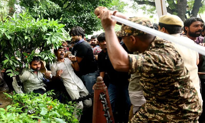 A security officer wields his baton against demonstrators at a protest site during a planned march by supporters of India's Cockroach Janta Party towards parliament demanding the resignation of Education Minister Dharmendra Pradhan over exam paper leaks near Jantar Mantar, New Delhi, India.-- Reuters A security officer wields his baton against demonstrators at a protest site during a planned march by supporters of India's Cockroach Janta Party towards parliament demanding the resignation of Education Minister Dharmendra Pradhan over exam paper leaks near Jantar Mantar, New Delhi, India.-- Reuters