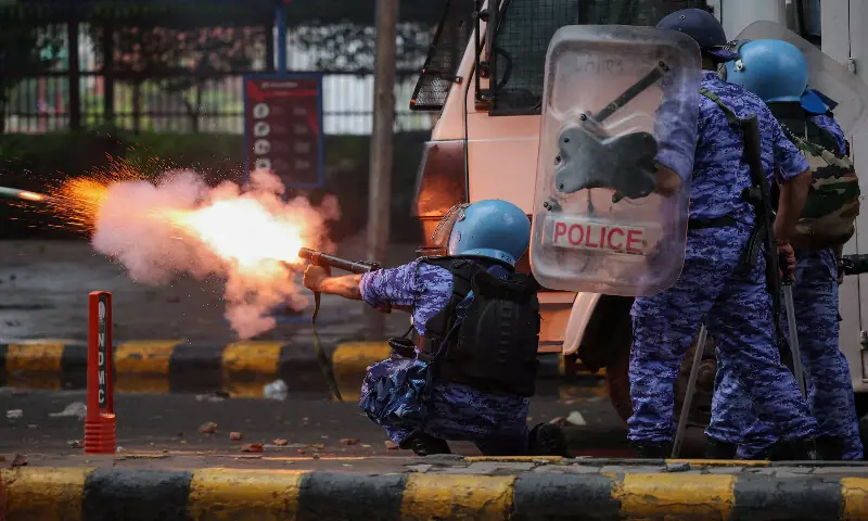A member of the Rapid Action Force fires a tear gas shell towards protesters in New Delhi. -- Reuters A member of the Rapid Action Force fires a tear gas shell towards protesters in New Delhi. -- Reuters