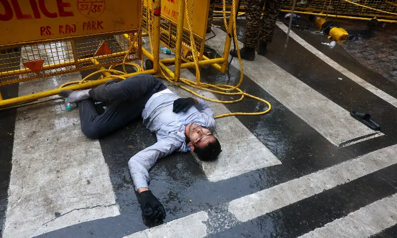 A man lies on the ground after clashes between protesters and police in New Delhi. -- Reuters A man lies on the ground after clashes between protesters and police in New Delhi. -- Reuters