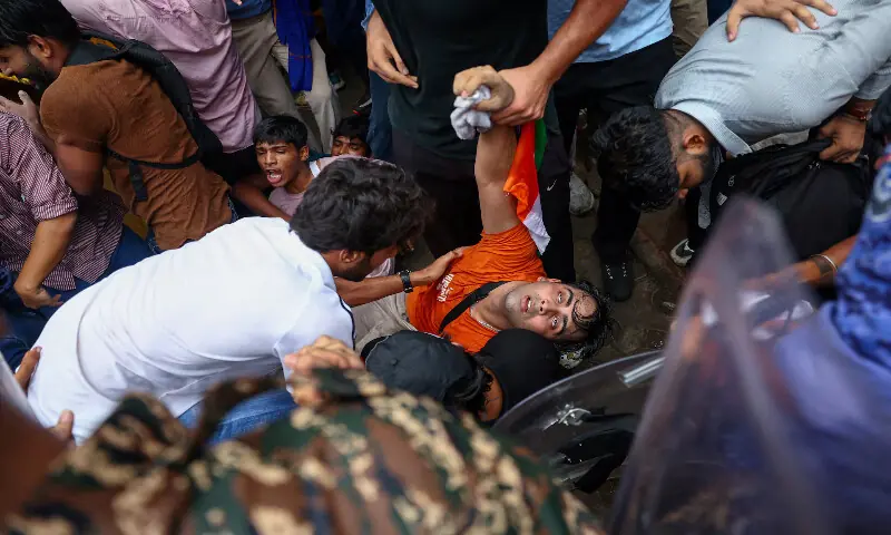 A protester falls down following clashes with members of law enforcement in New Delhi. -- Reuters A protester falls down following clashes with members of law enforcement in New Delhi. -- Reuters