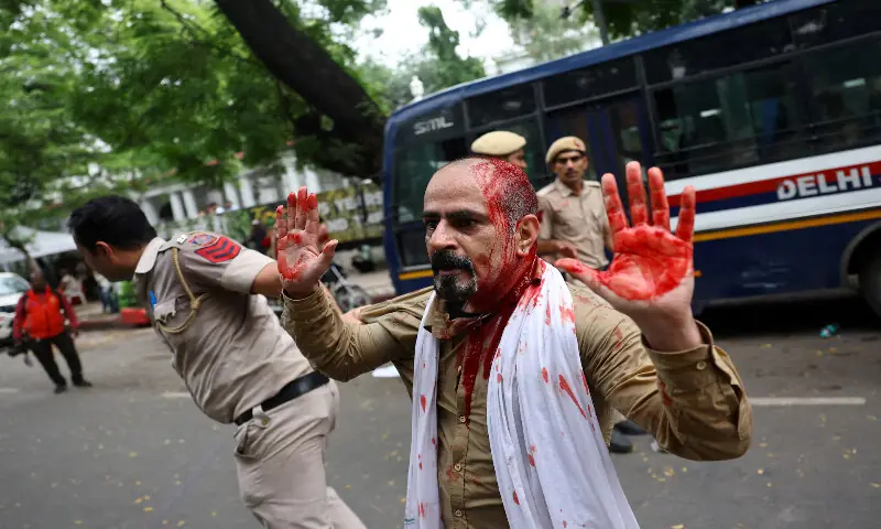 An injured demonstrator is detained by police during the protest in New Delhi. -- Reuters An injured demonstrator is detained by police during the protest in New Delhi. -- Reuters
