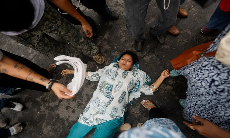 A woman lies on the ground during the protest in New Delhi. -- Reuters A woman lies on the ground during the protest in New Delhi. -- Reuters