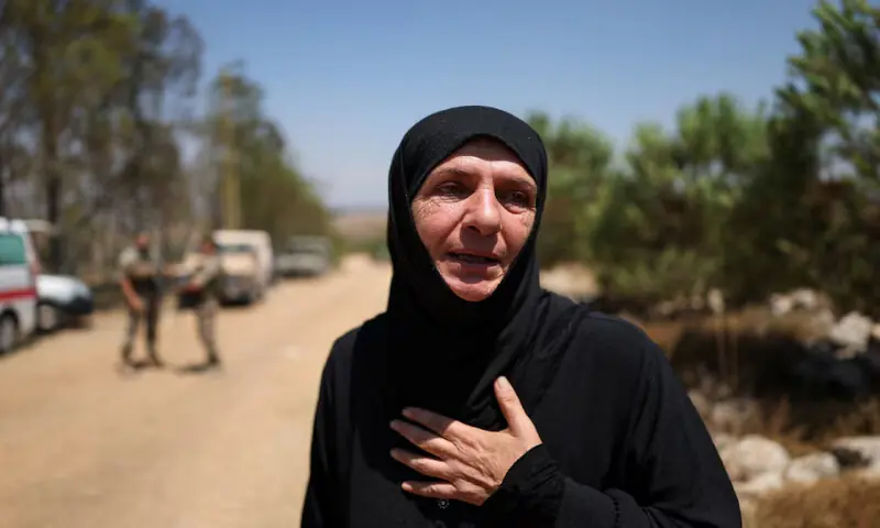A villager waits at the entrance of her village, Zawtar al-Gharbiyeh, in southern Lebanon on Tuesday. -- Reuters A villager waits at the entrance of her village, Zawtar al-Gharbiyeh, in southern Lebanon on Tuesday. -- Reuters