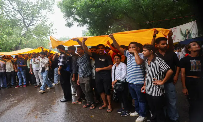 Supporters of Cockroach Janta Party take shelter under a sheet at a protest site in New Delhi, India. -- Reuters Supporters of Cockroach Janta Party take shelter under a sheet at a protest site in New Delhi, India. -- Reuters