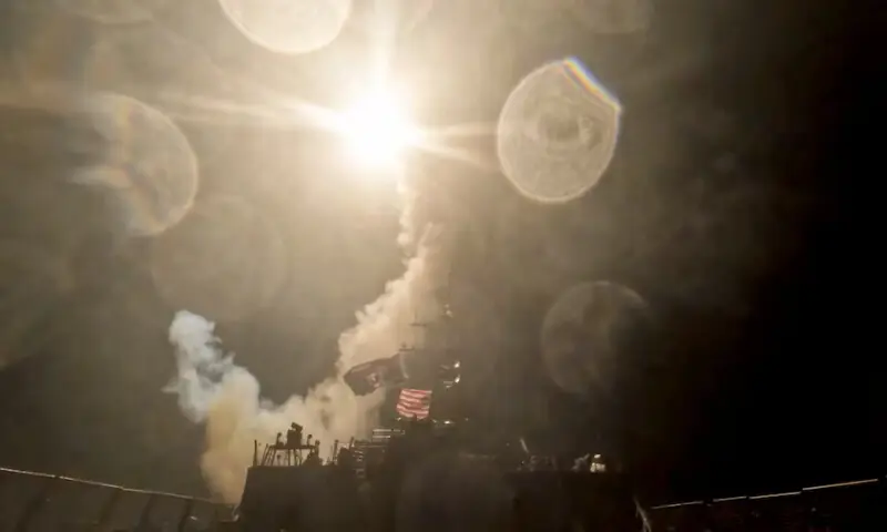 A US warship launches a munition at an unknown location during what the US military says is its latest wave of strikes on Iran in this still image taken from a handout video. -- Reuters