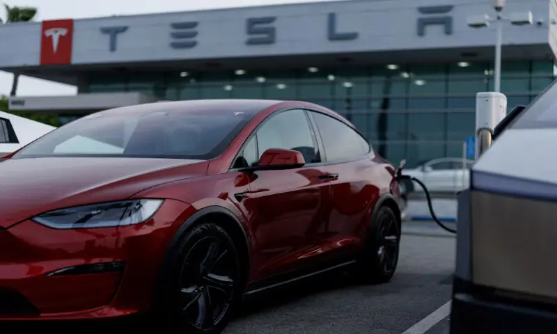 A Tesla model Y is shown charging at a Tesla dealership in Buena Park, California, US. -- Reuters