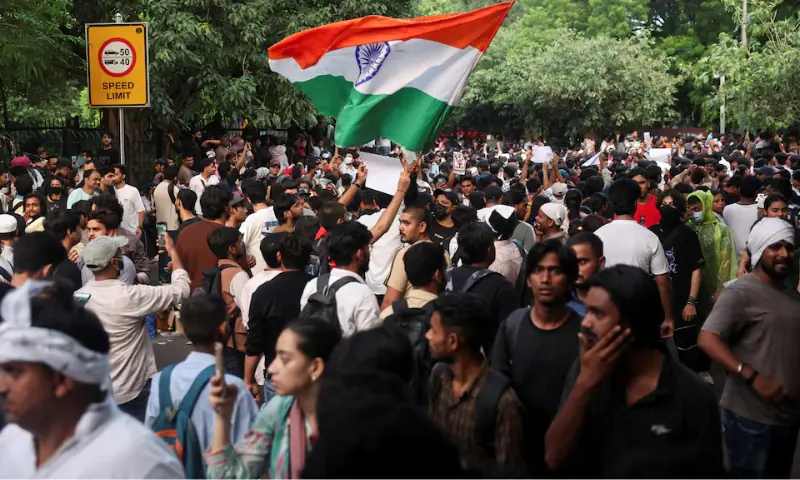A supporter of India's Cockroach Janata Party (CJP) holds an Indian national flag at the protest site, a few days after thousands of protesters marched towards parliament demanding the resignation of Education Minister Dharmendra Pradhan over National Eligibility cum Entrance Test (NEET) examination paper leaks, at Jantar Mantar in New Delhi, India. -- Reuters