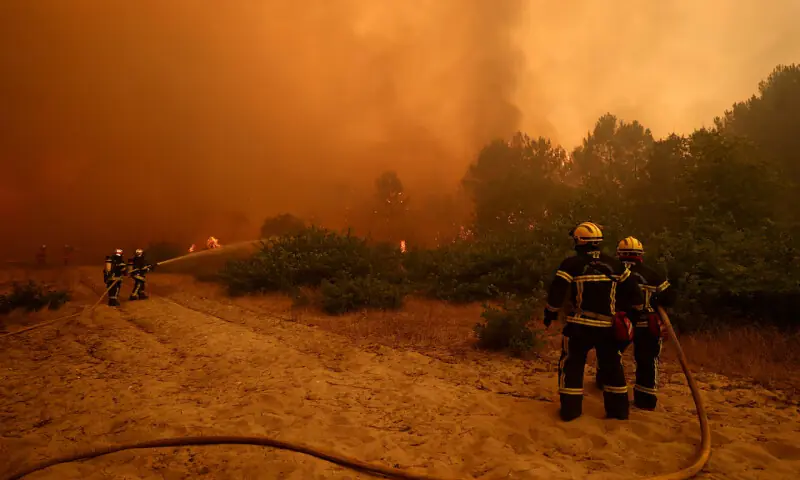 Firefighters work to extinguish flames during a wildfire in Lege-Cap-Ferret in the Gironde department, France. -- Reuters Firefighters work to extinguish flames during a wildfire in Lege-Cap-Ferret in the Gironde department, France. -- Reuters