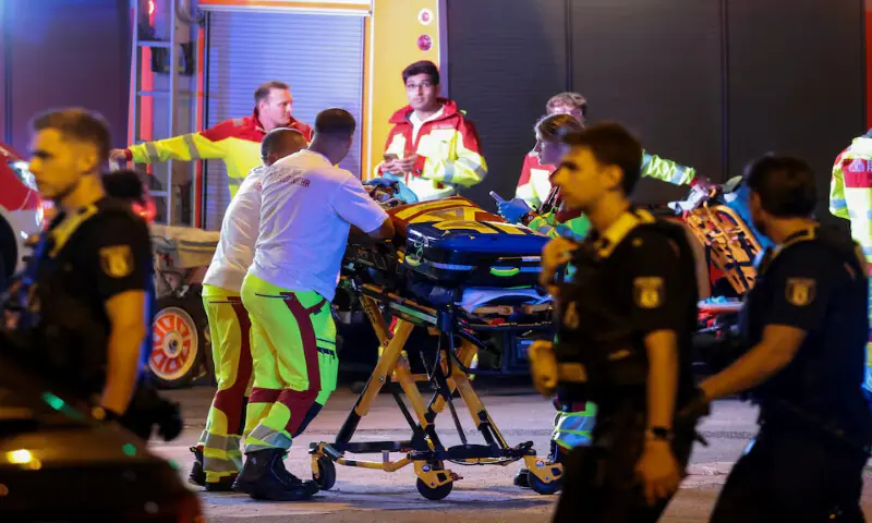 Emergency responders assist a person at the site after a car crashed into the crowd at Tiergarten park in Berlin, Germany. -- Reuters