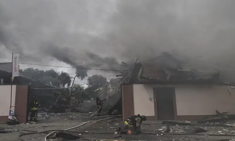 Rescuers work at a site of the drinking water delivery company hit in an air strike in Zaporizhzhia, Ukraine. -- Reuters