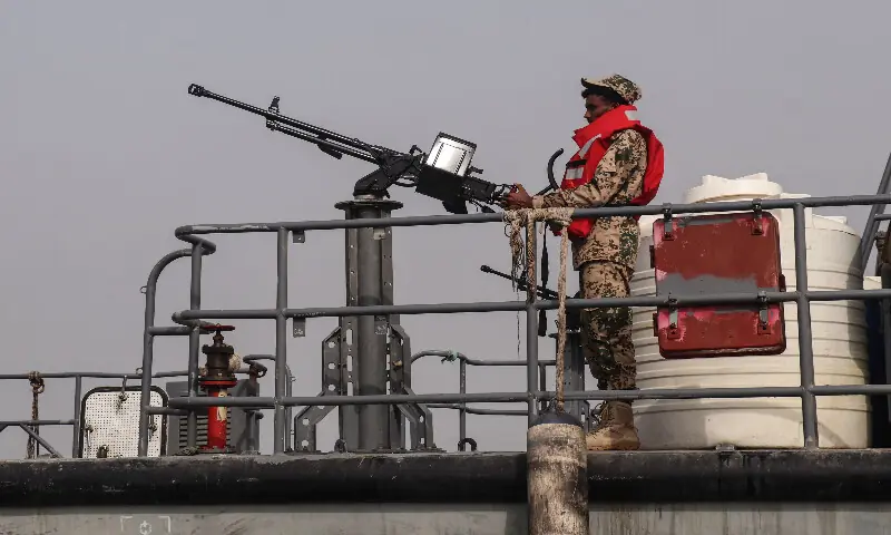 A sailor from the navy of Yemen's Aden-based internationally recognised government stands at a machine-gun position aboard a vessel patrolling a shipping lane off Hanish Island in the Red Sea on July 27, 2026. AFP