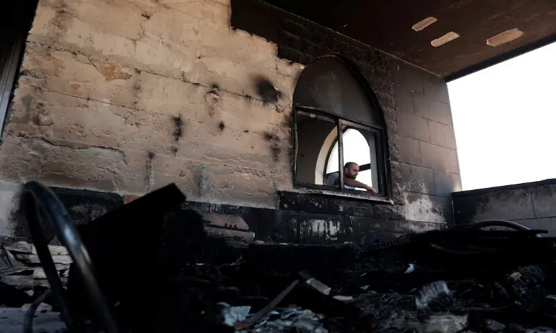 A Palestinian man inspects the damage at a mosque which was damaged by Israeli settlers in Qusra near Nablus in the Israeli-occupied West Bank. -- Reuters