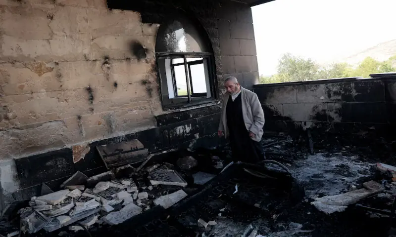 A Palestinian man inspects the damage at a mosque which was damaged by Israeli settlers in Qusra near Nablus in the Israeli-occupied West Bank. -- Reuters