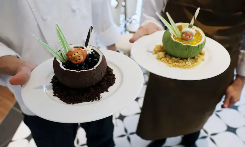 Chefs present the Twinkle Twinkle Tangy Coconut Mousse and Twinkle Twinkle Sweet Coconut Mousse desserts at Pop Mart's first international bakery at Resorts World Sentosa in Singapore. -- Reuters