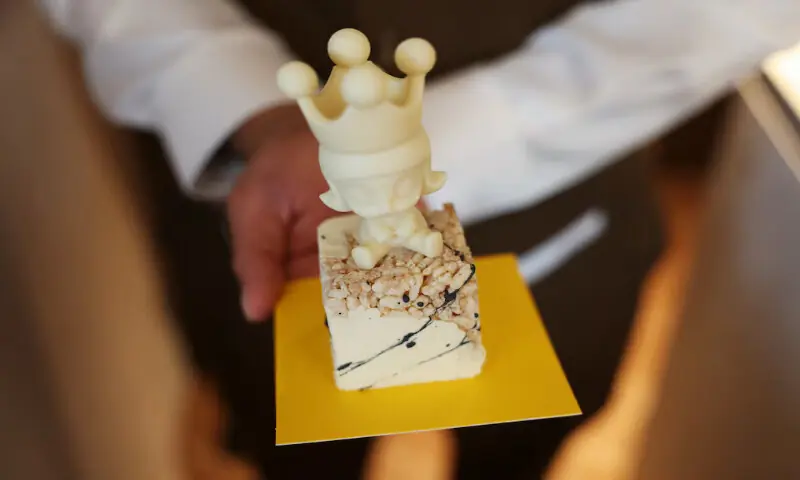 A service staff shows a double cheesecake Molly sold at Pop Mart's first international bakery at Resorts World Sentosa in Singapore. -- Reuters