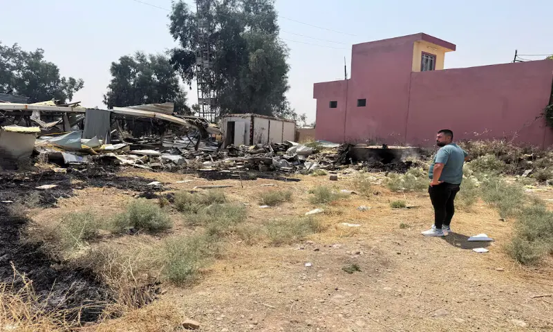 A man looks on near damage at a site belonging to Iraq's Popular Mobilization Forces following air strikes in Bartella, Nineveh province, Iraq. -- Reuters