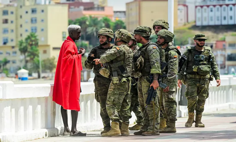 Spanish soldiers question a migrant in Ceuta, Spain. -- Reuters Spanish soldiers question a migrant in Ceuta, Spain. -- Reuters