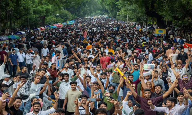 Thousands of protesters celebrated the resignation of Education Minister Dharmendra Pradhan in New Delhi on July 25. His departure after questions for a medical school exam were leaked was a rare concession by the Modi government. -- Reuters