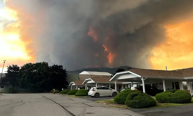 Smoke rises from the Bald Range wildfire over a residential street in Summerland, British Columbia, Canada. -- Reuters
