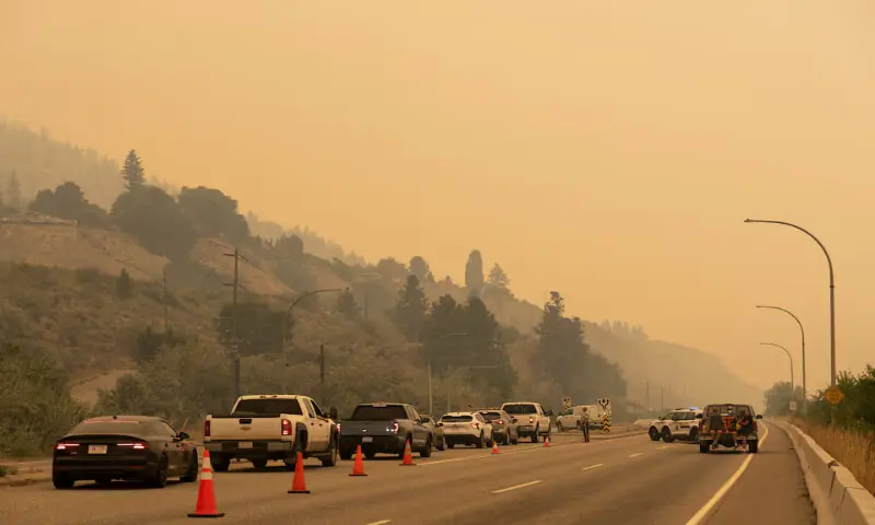 The Royal Canadian Mounted Police block Highway 97 Northbound to direct people away from the Bald Range wildfire in Penticton, British Columbia, Canada. -- REuters