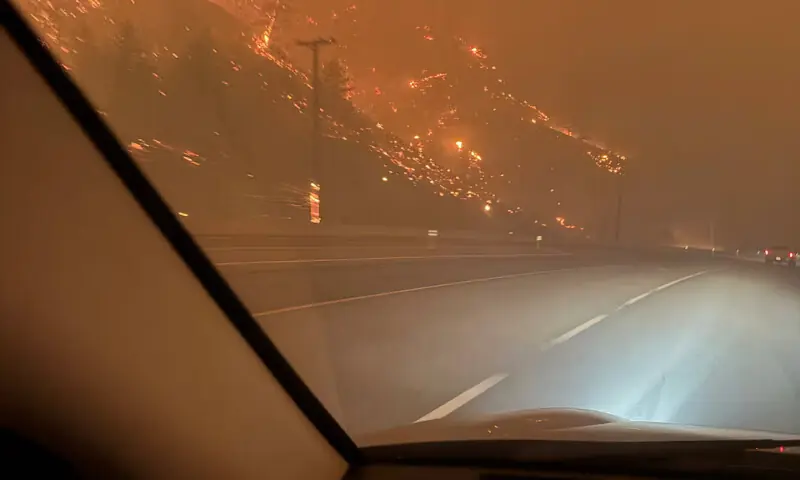 The hillside burns as residents evacuate towards Kelowna after midnight from the Bald Range wildfire along Highway 97 near Summerland, British Columbia, Canada. -- Reuters