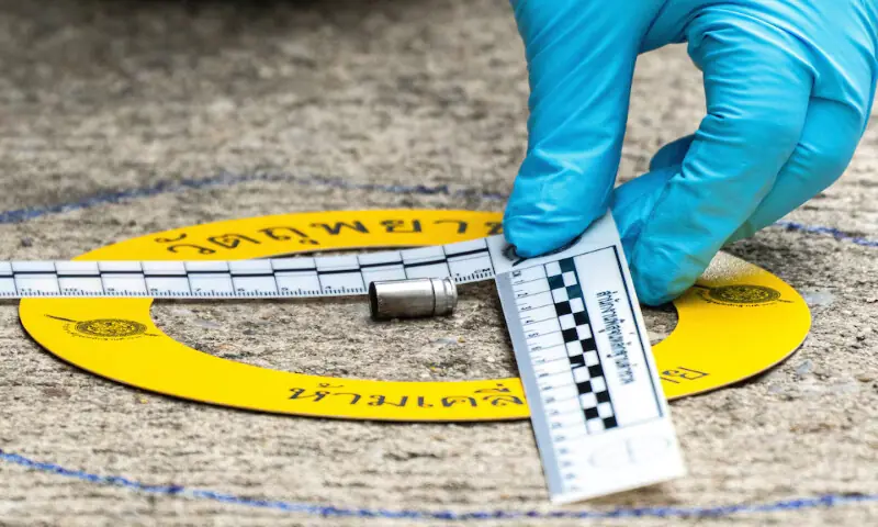 A forensic police officer inspects the site of a shooting in Nonthaburi province, on the outskirts of Bangkok, Thailand. -- Reuters A forensic police officer inspects the site of a shooting in Nonthaburi province, on the outskirts of Bangkok, Thailand. -- Reuters