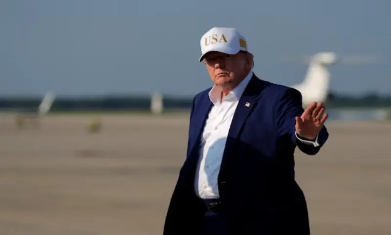 US President Donald Trump waves as he disembarks Air Force One at Joint Base Andrews, Maryland, US. -- Reuters