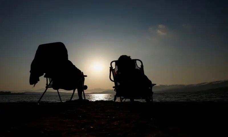 Patricia Molera and Enrique Sotomayor test their eclipse glasses during sunset at Arija beach, Spain. -- Reuters