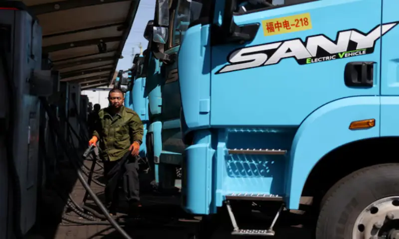 A driver uses a charging station to charge a Sany electric heavy truck at a fleet depot equipped with electric truck charger, in Tangshan, Hebei province, China. -- Reuters