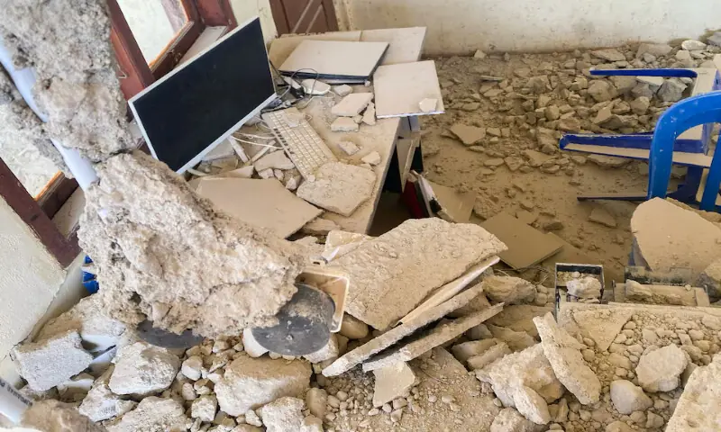 A monitor stands among debris at a building collapse following an earthquake of magnitude 7.7 in Golo Lewe village, West Manggarai, East Nusa Tenggara, Indonesia, on Saturday. -- Reuters