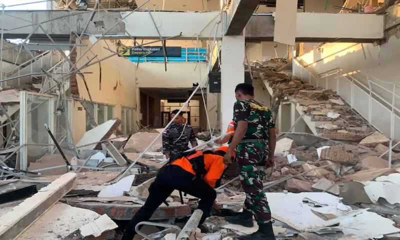 Rescuers inspect a heavily-damaged building at L. Say port following an earthquake in Sikka, East Nusa Tenggara province, Indonesia. -- Reuters